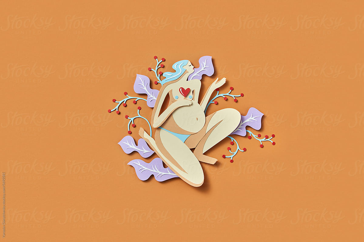 Papermade naked woman with pregnant belly among blossoms