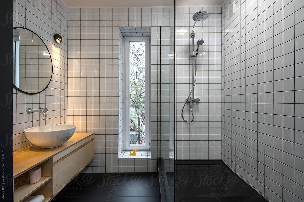 Small modern bathroom with a dark floor, mirror frame, and hardware