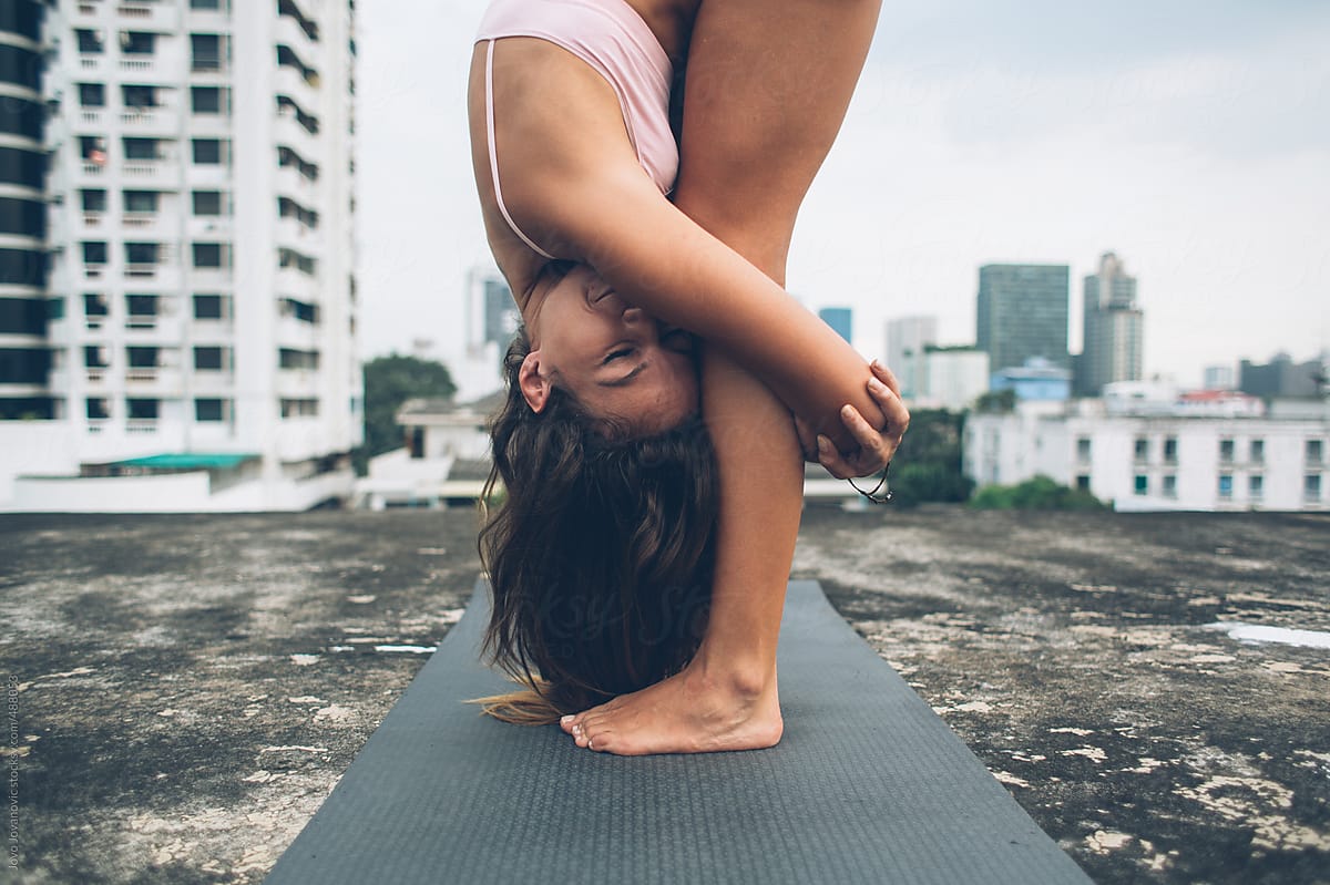 Yoga girl hugging her knees with her eyes closed