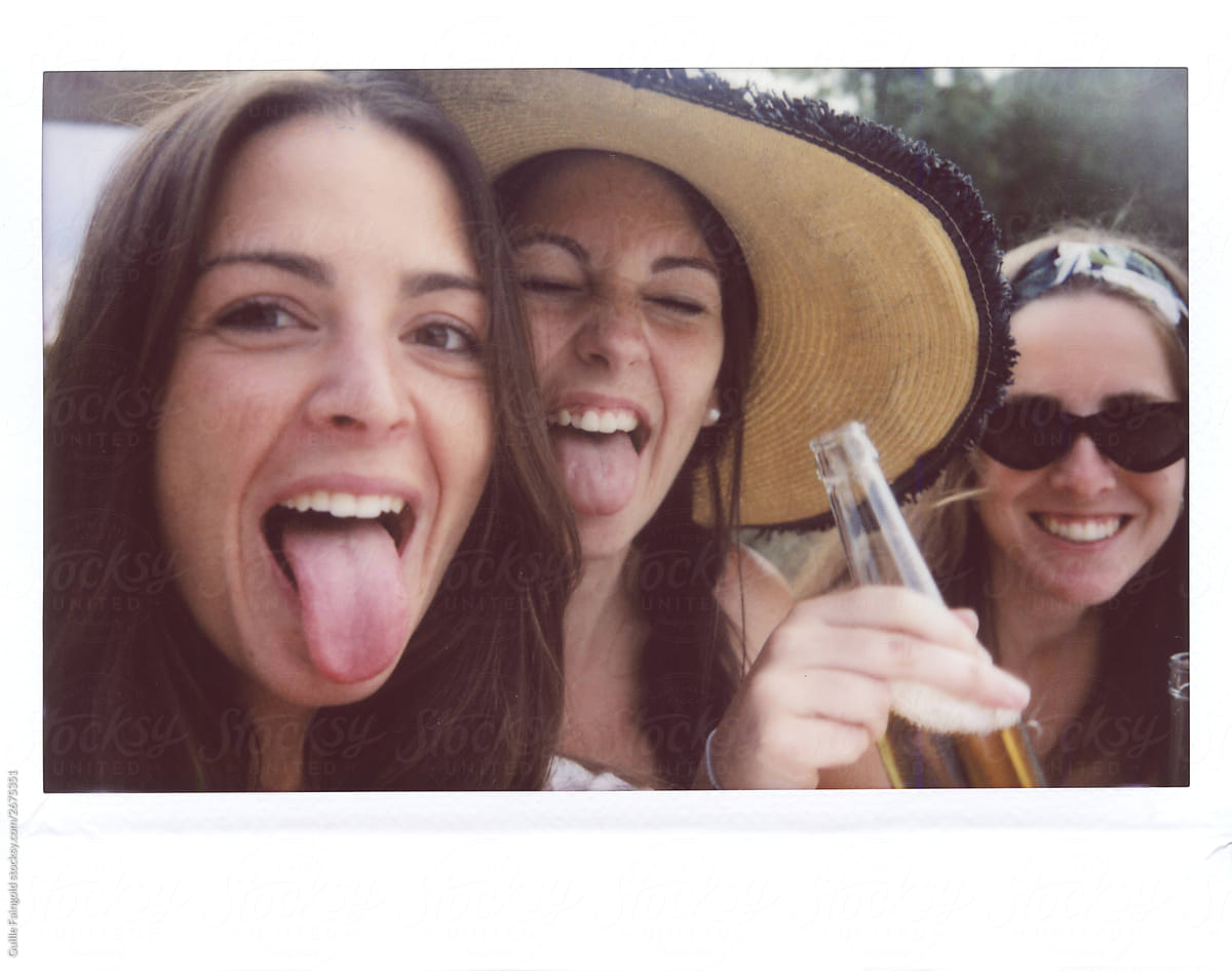 Three Teen Girls Showing Their Tongue To Camera by Stocksy