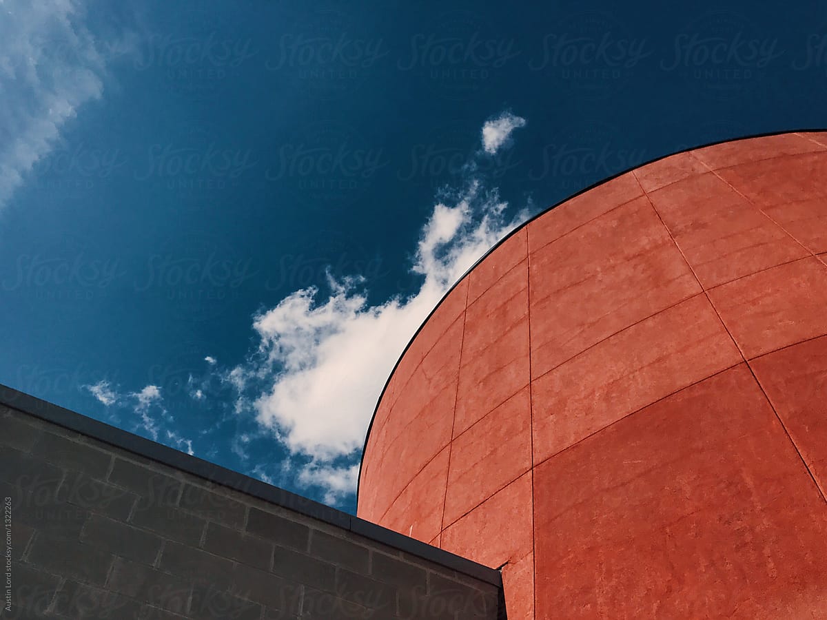 Shot of a red building with the sky as the background