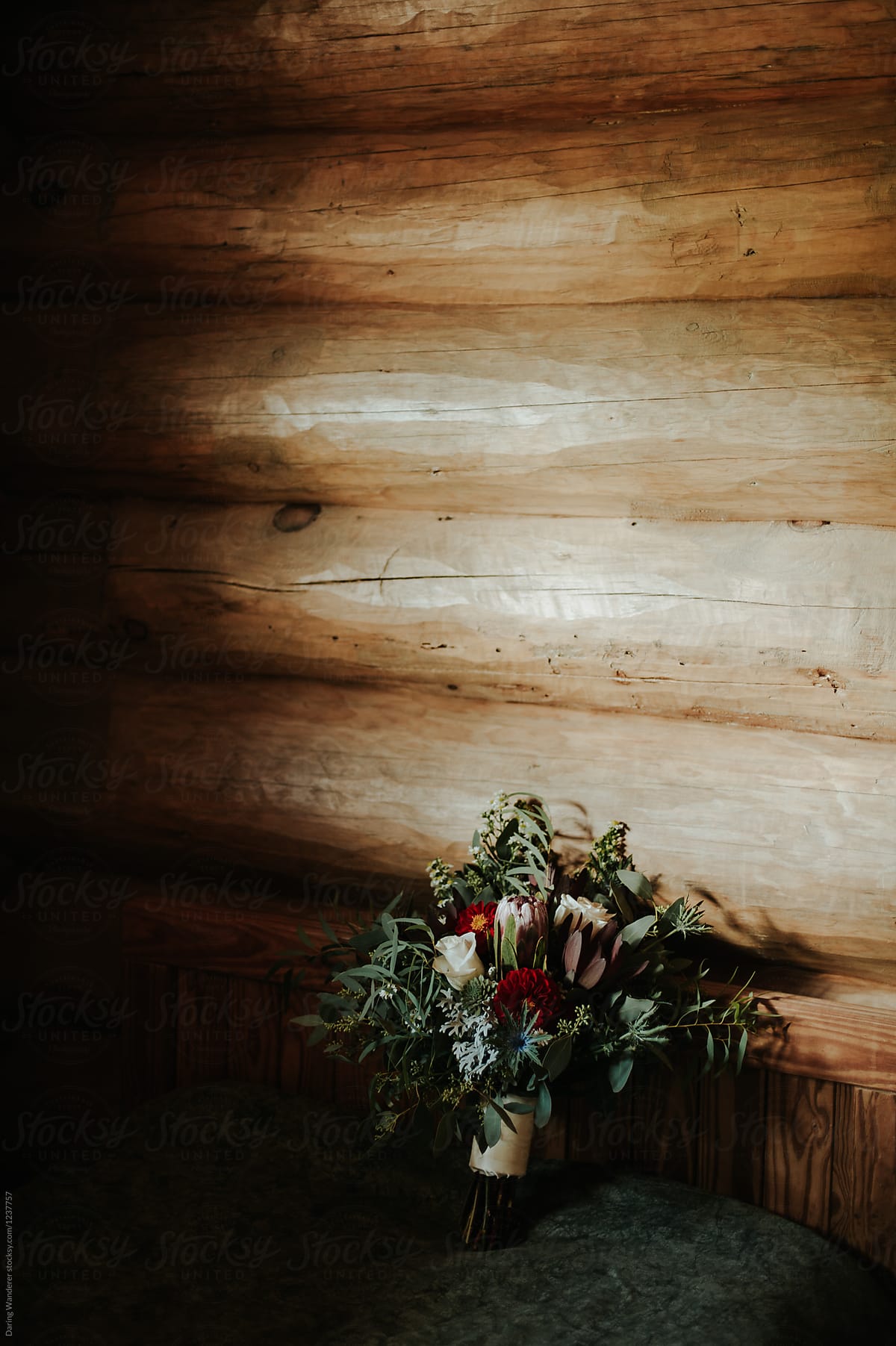 Moody protea and white rose wedding bouquet in log cabin