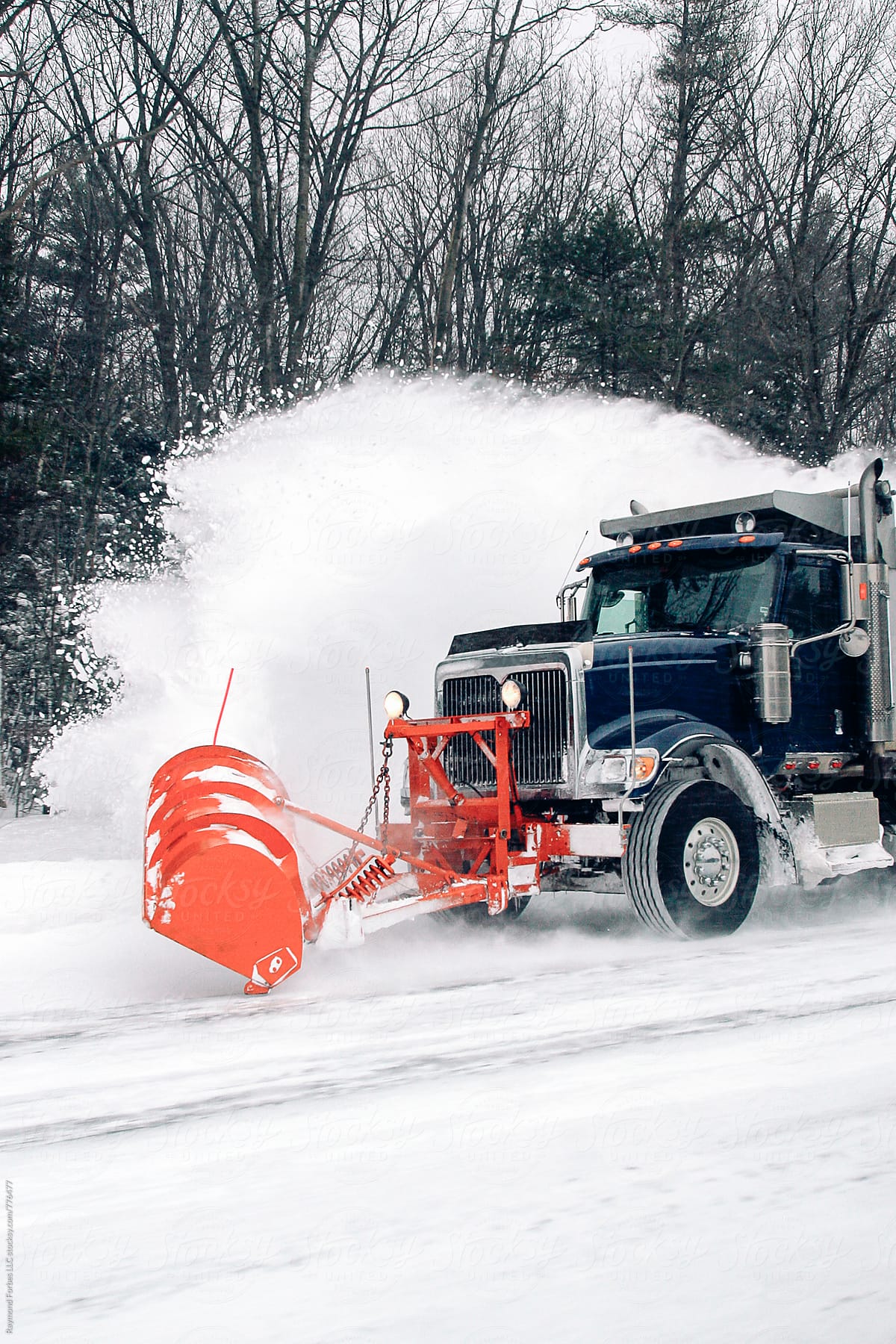 Cold Winter landscape Truck Plowing Snow on highway
