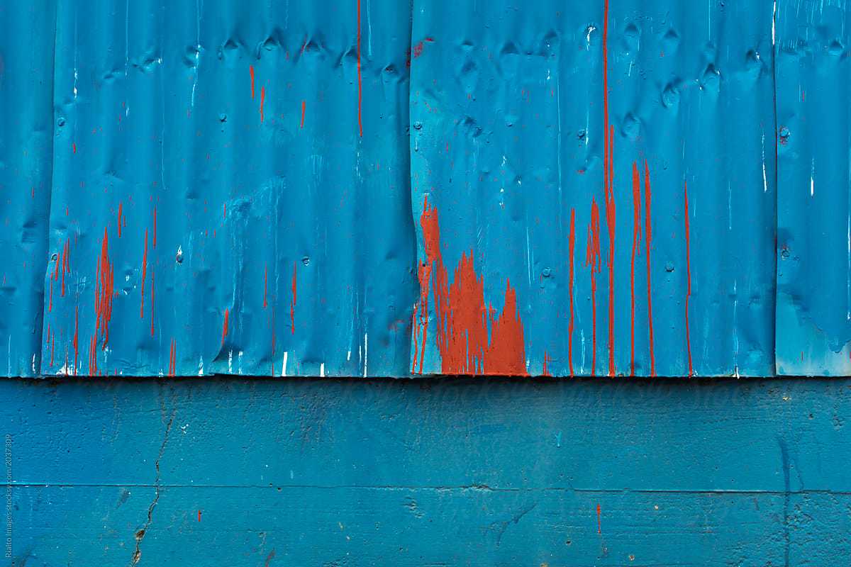 Dripping red paint on warehouse wall
