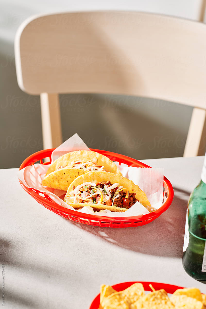 Appetizing tacos placed on table in cafe
