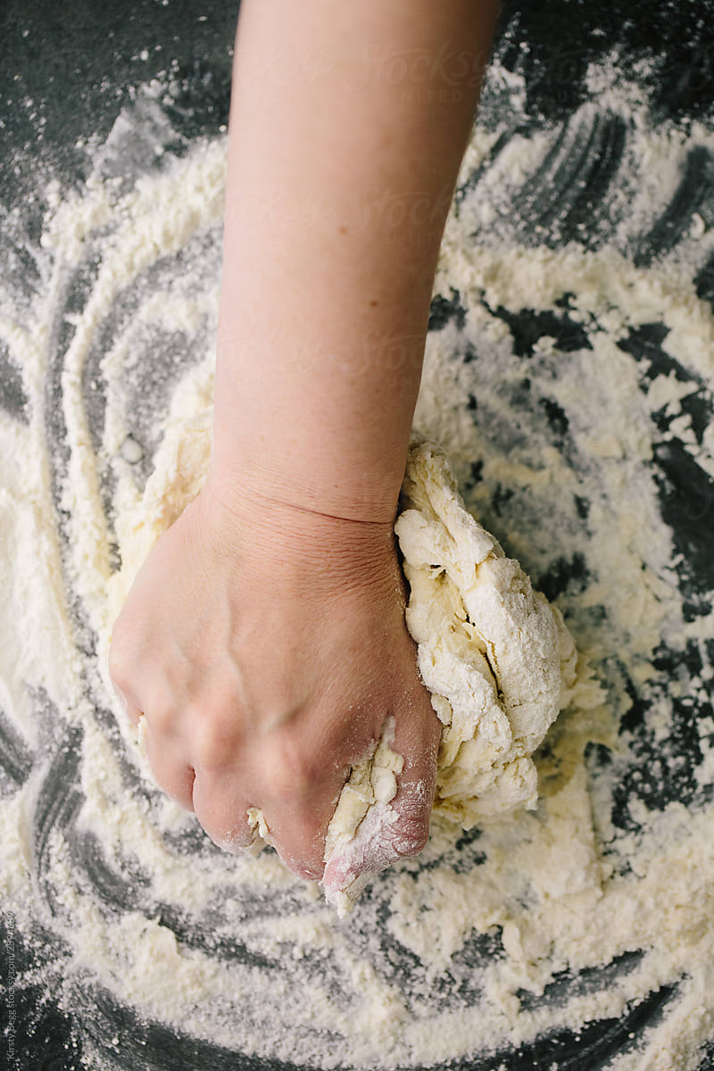 Woman kneading dough with hand