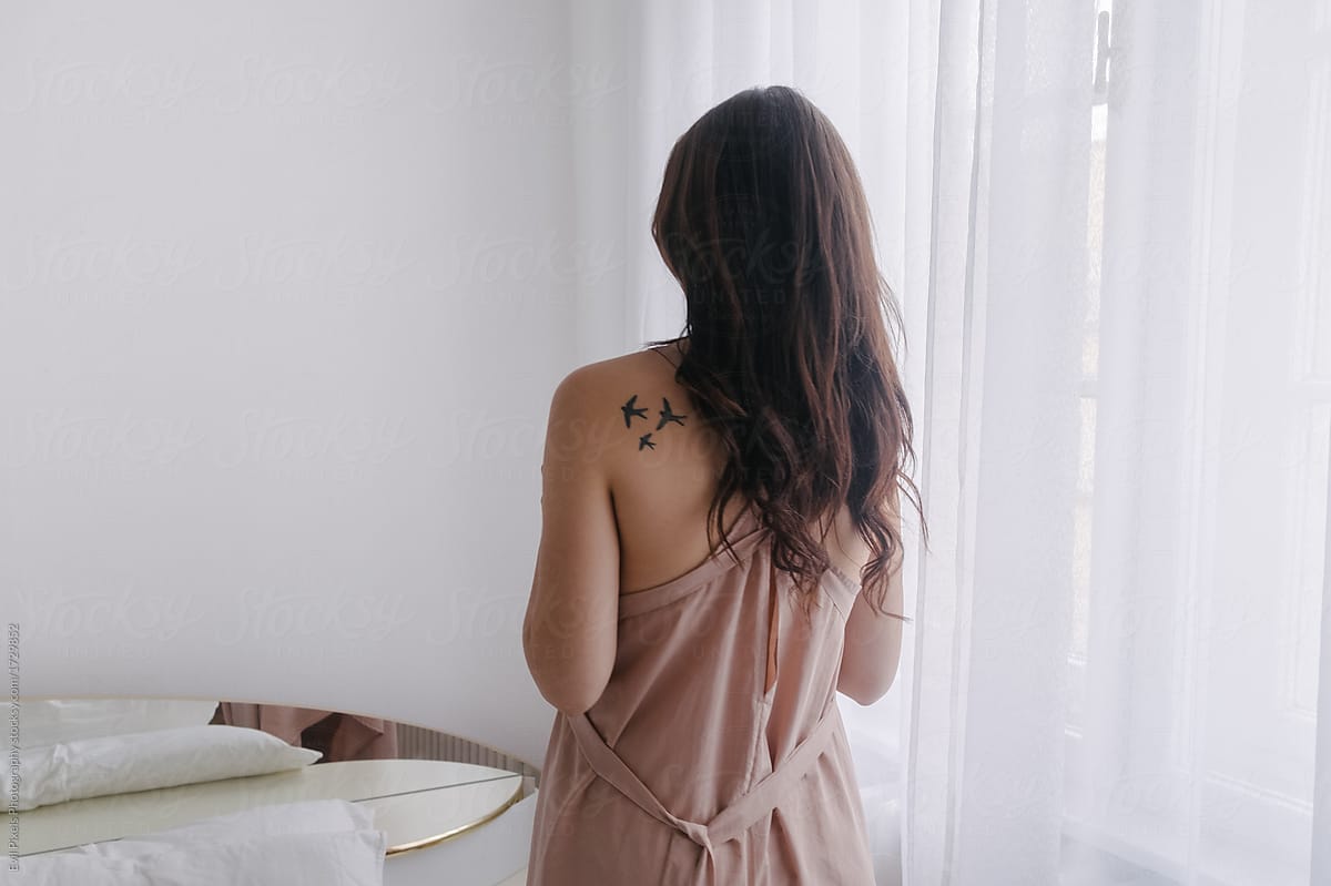 Brunette Girl With A Bird Tattoo On Her Back