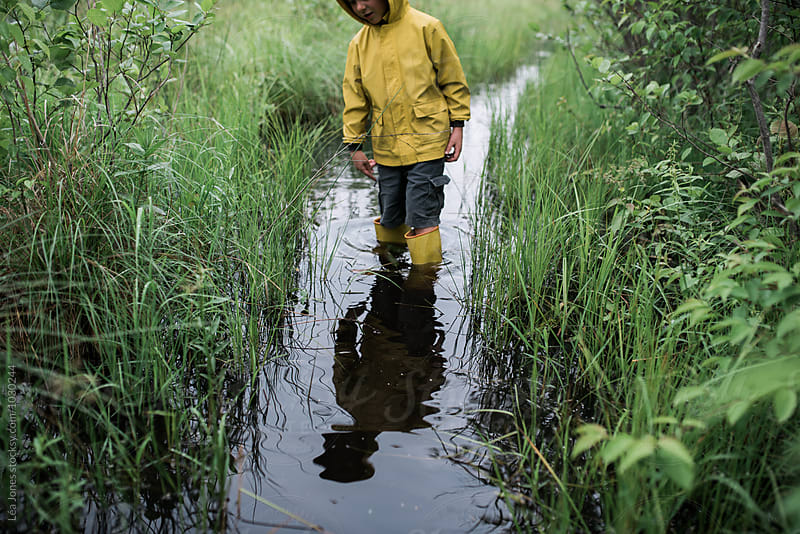 little boy on walk in a flooded path