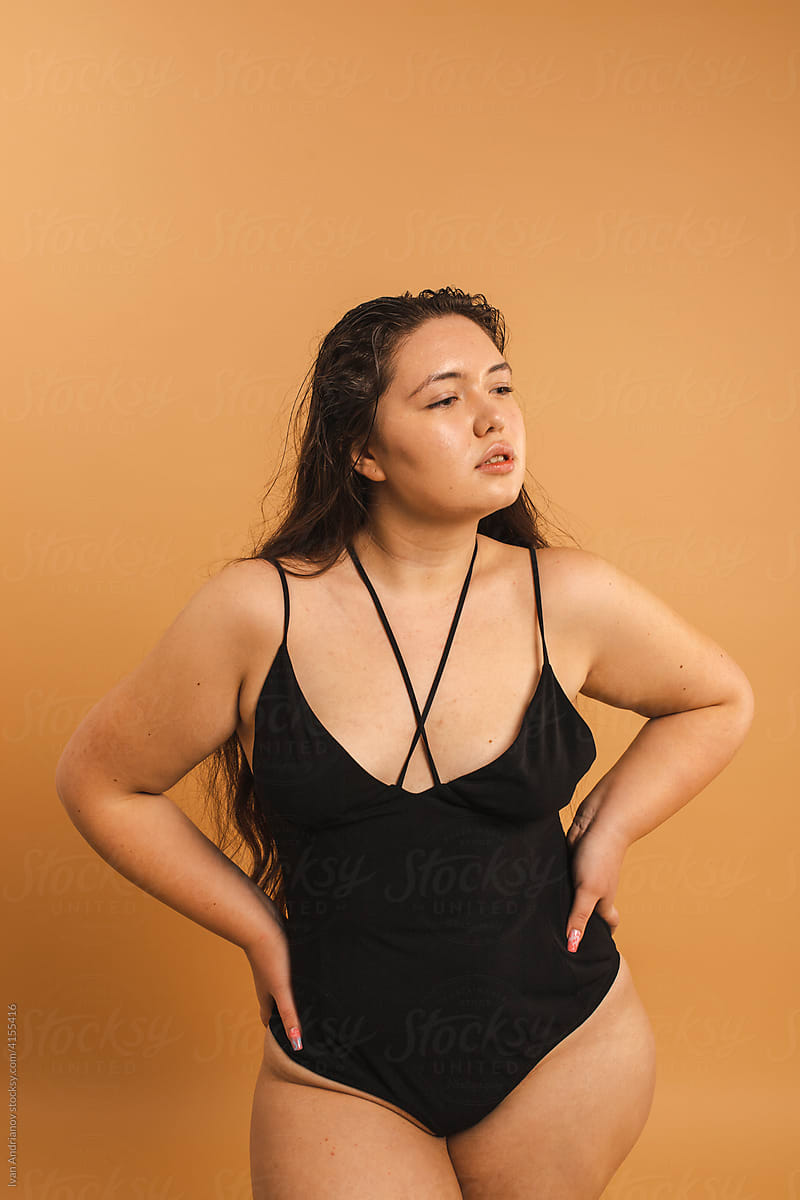 Beautiful curvy model standing  in black bodysuit