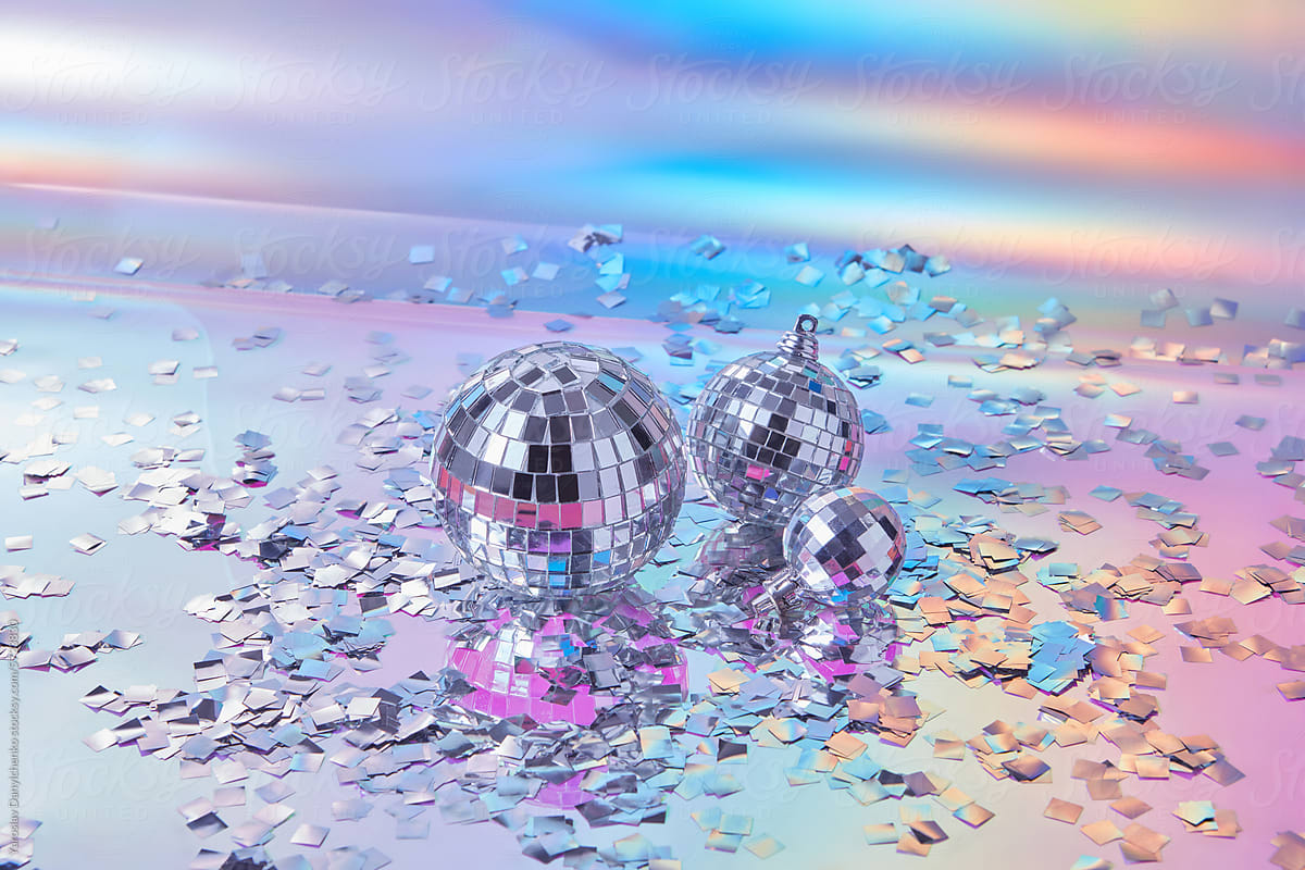 Decorative disco balls with silver confetti on iridescent background