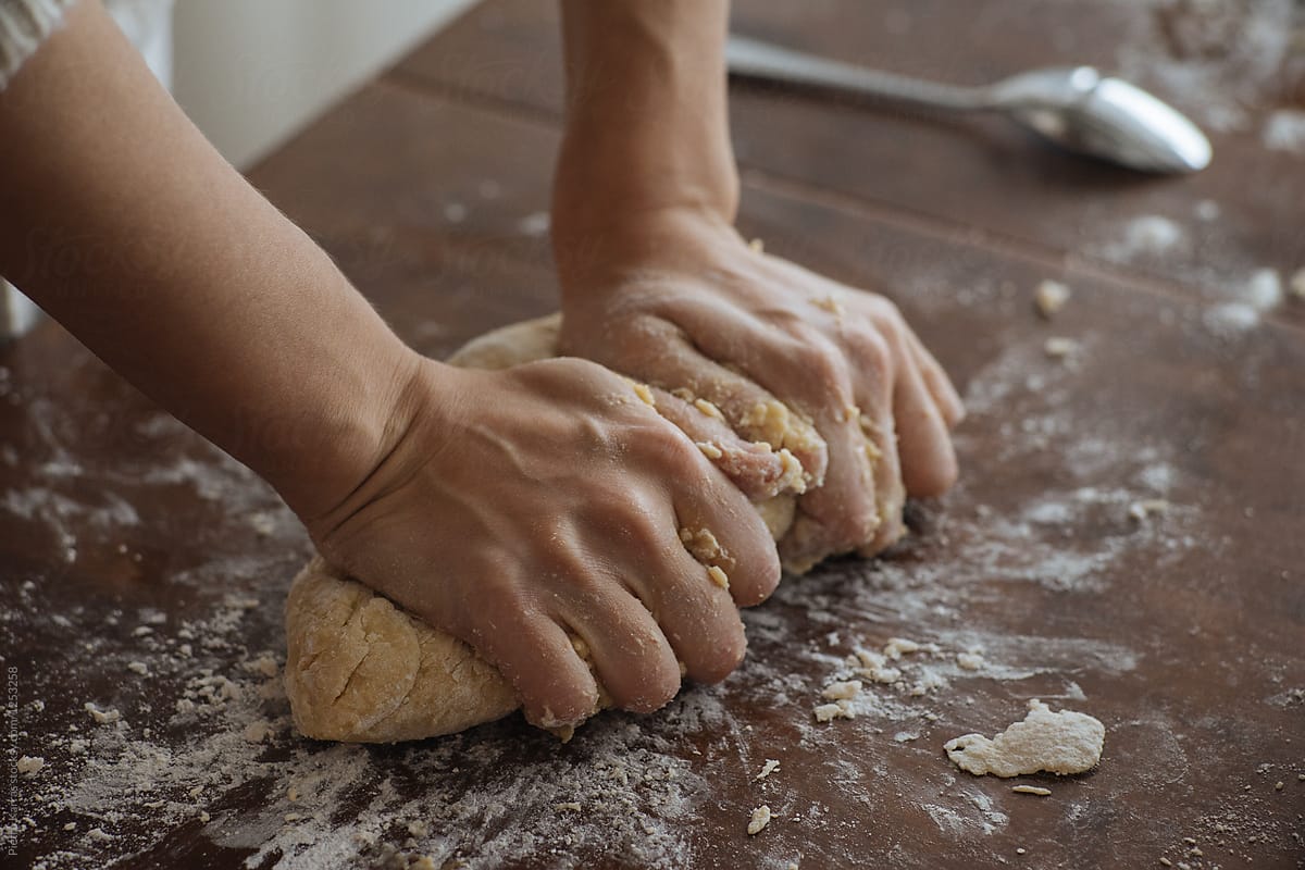 Hands of woman beating dough