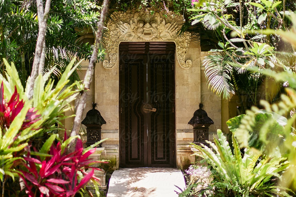 Beautiful wooden door in the garden of luxury balinese villa