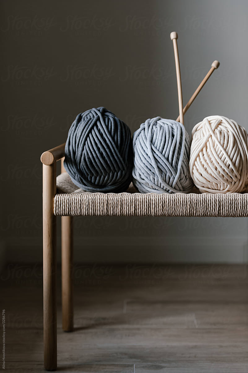 Natural Yarn And Wooden Knitting Needles On Chair by Stocksy Contributor  Alina Hvostikova - Stocksy