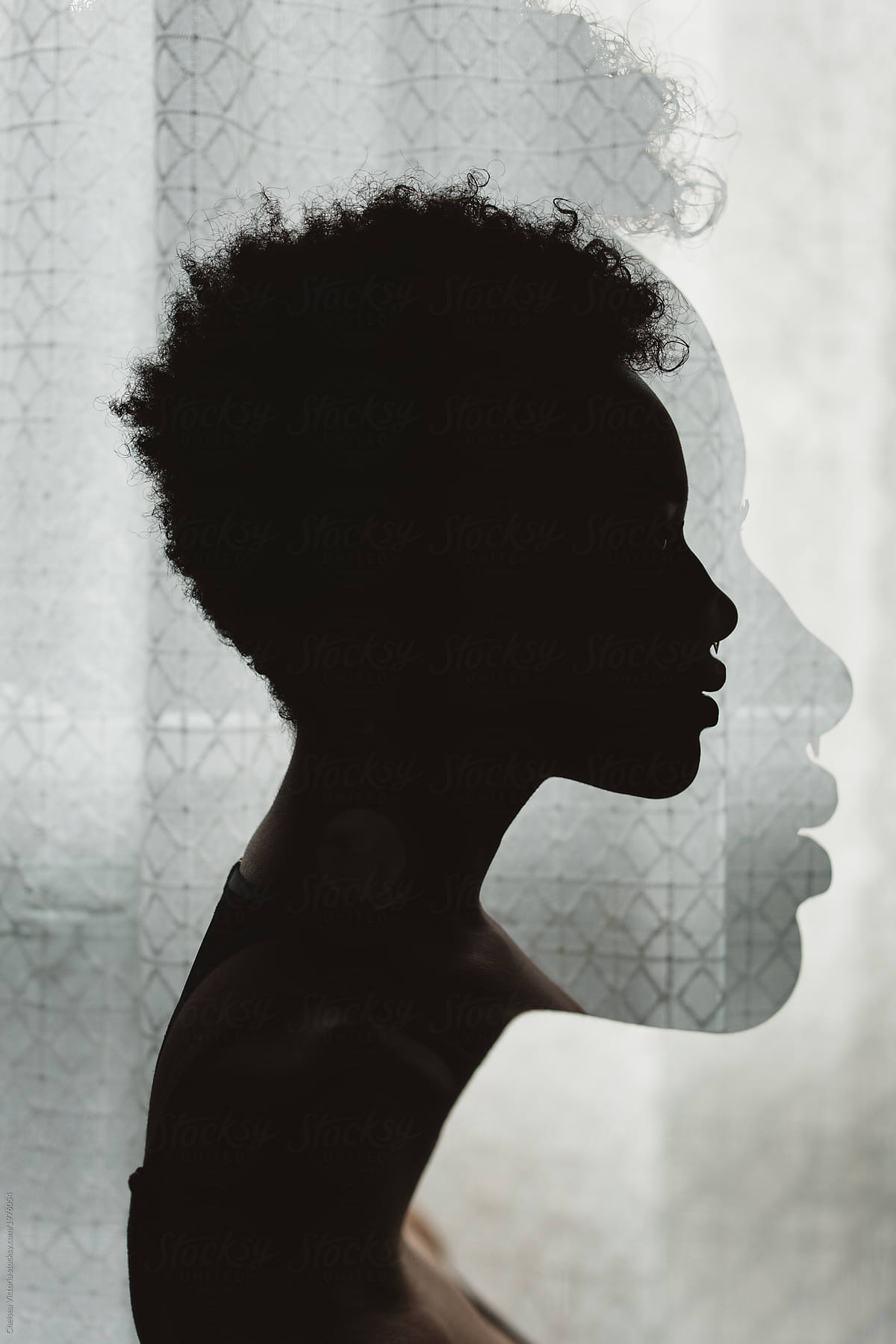 A young African American woman in silhouette