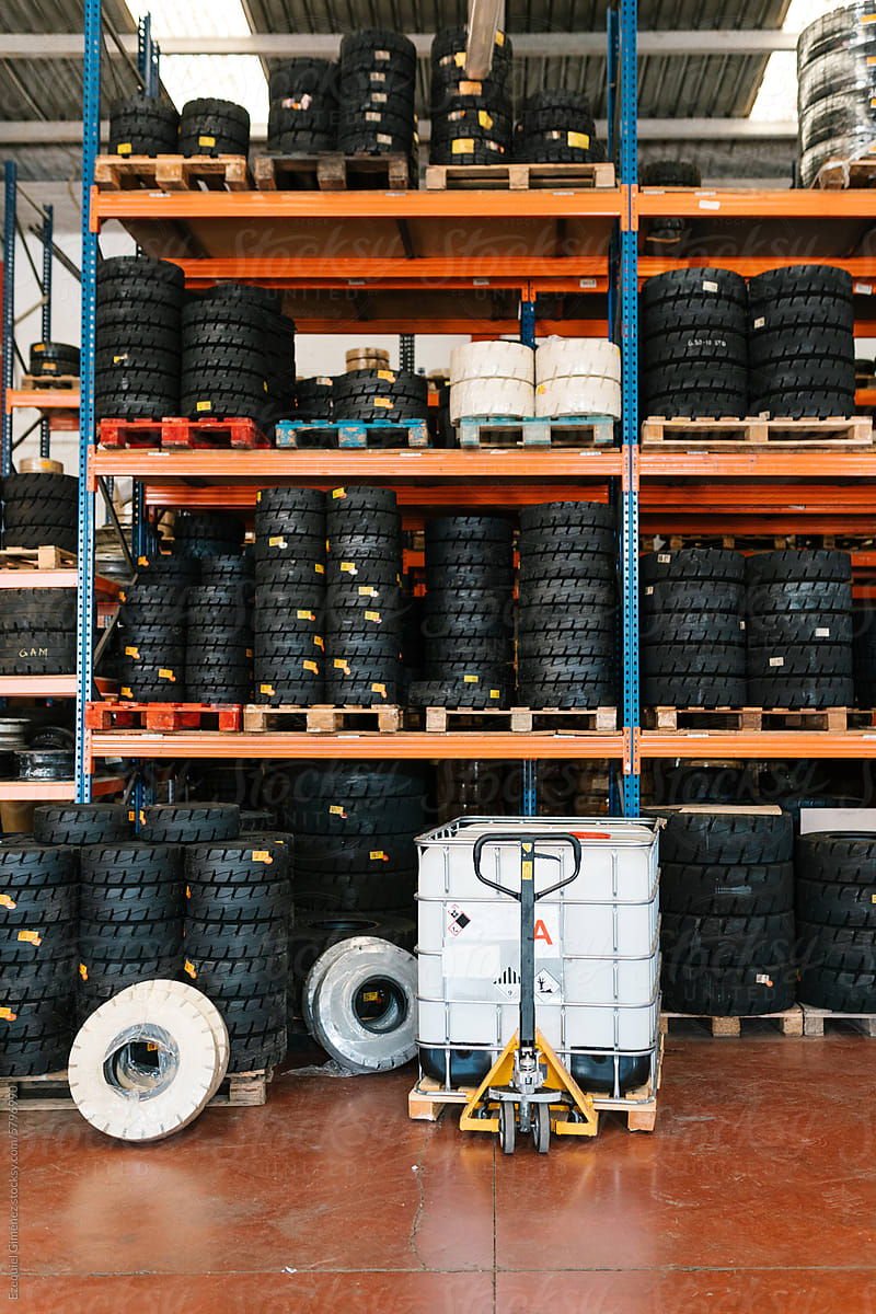 Vehicle wheels placed on shelves in garage at workshop