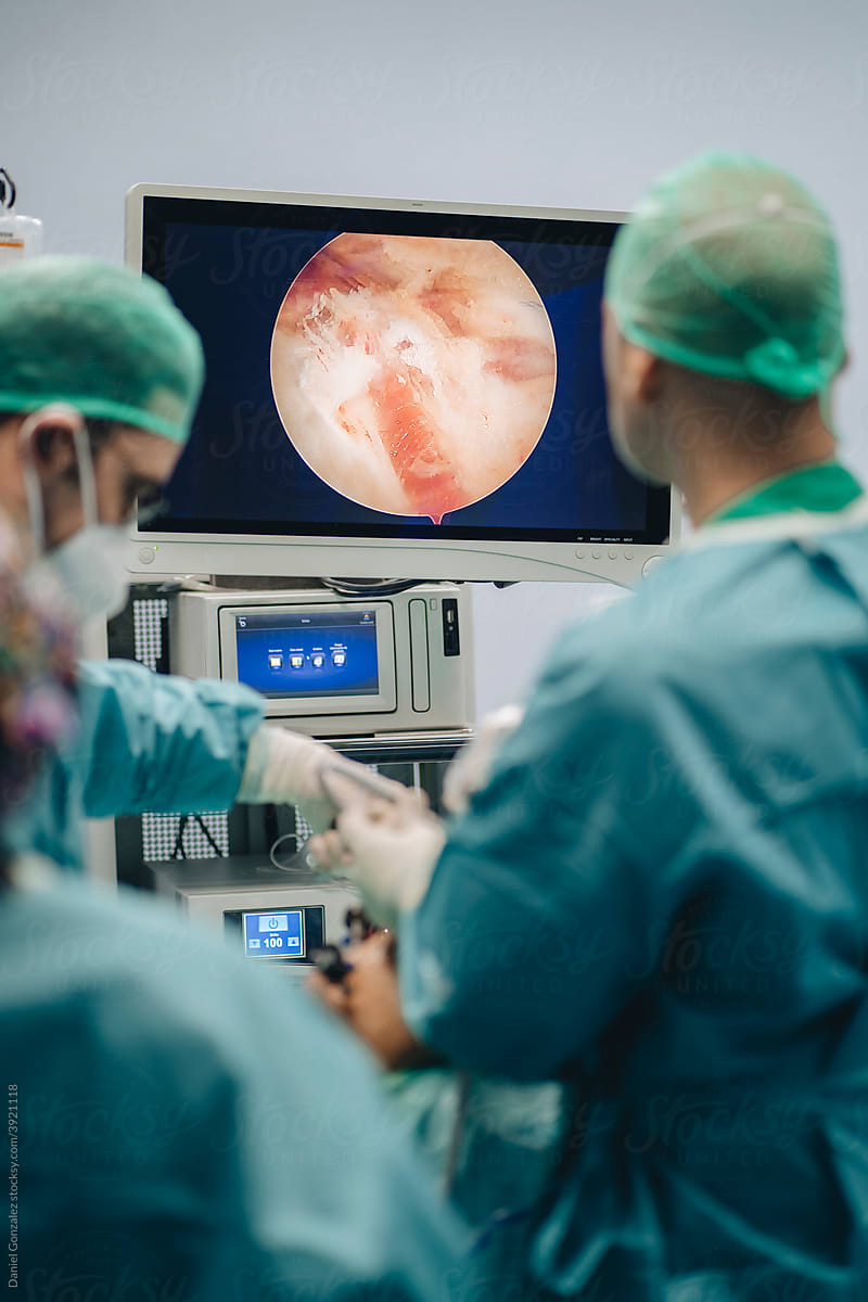 Surgeon looking at monitor during operation