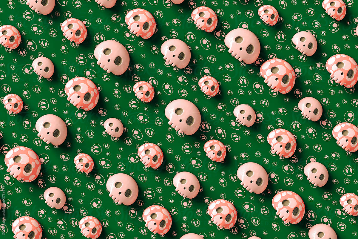 Pink skulls on green background