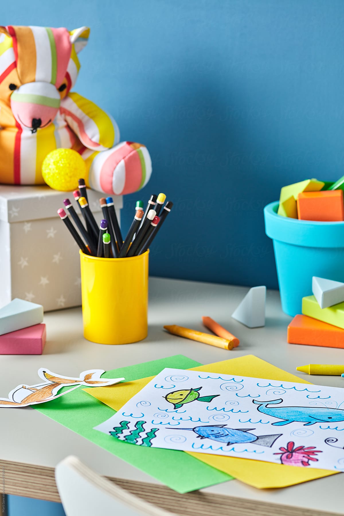 Close-up of child\'s painting with sea animals on desk
