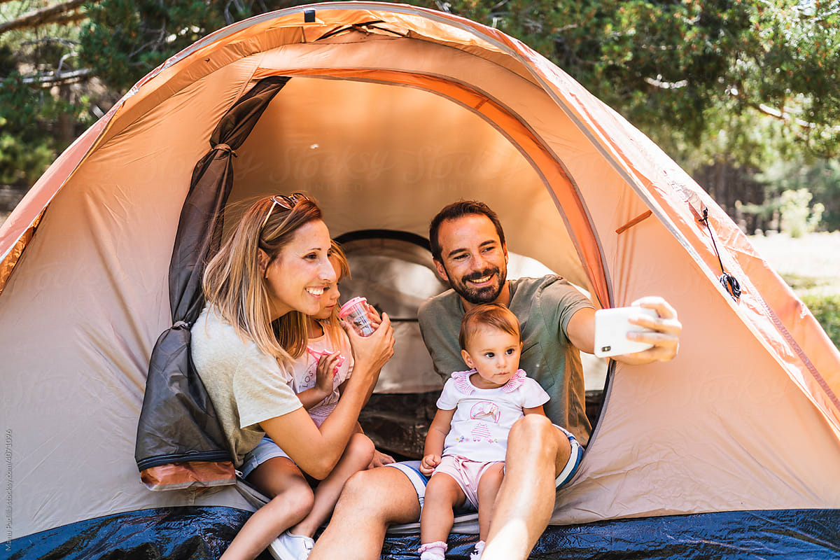 Family taking selfie in tent