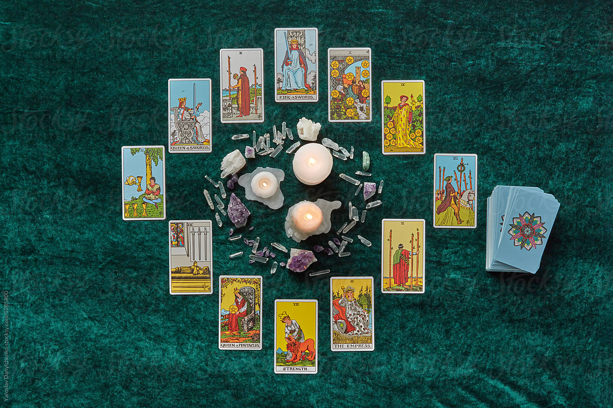 Tarot and magic crystals in a circle around candles.