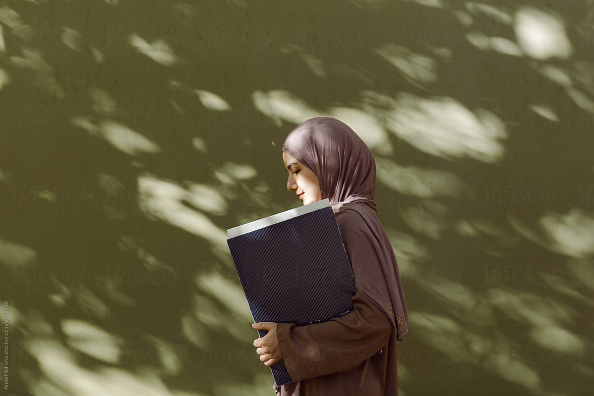 portrait of a young Muslim woman in the shade of trees