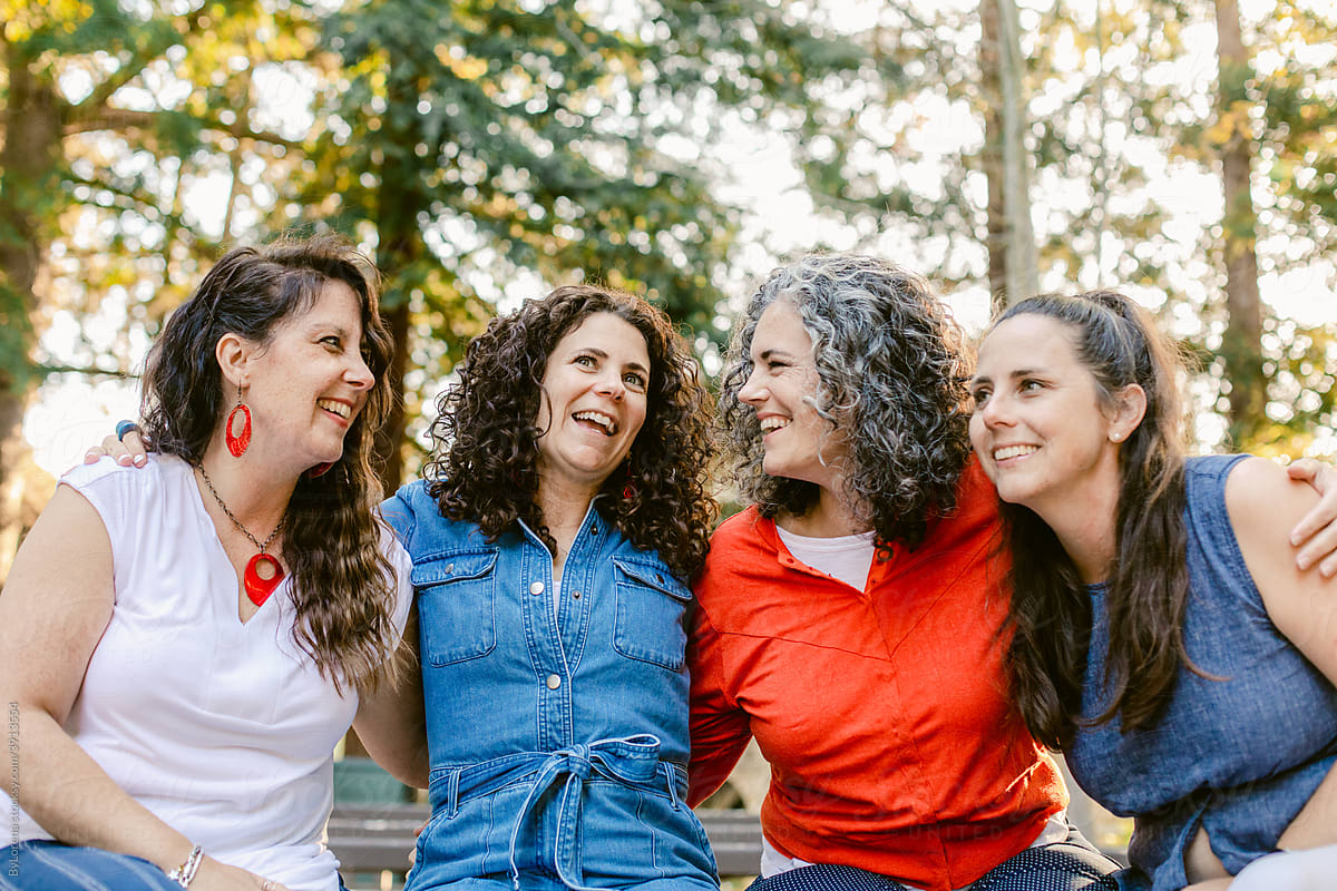 Group of friendly women embracing  at garden