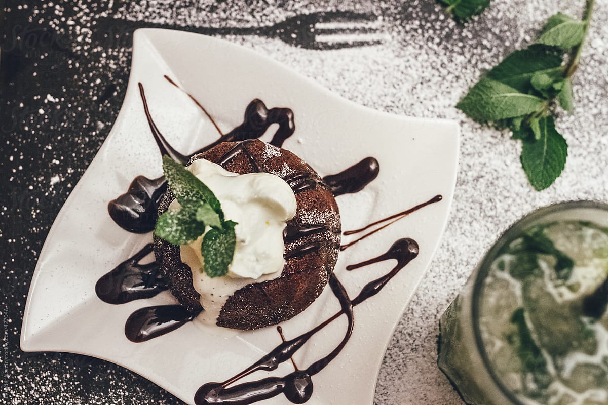 chocolate cake with whipped cream and a mojito from above
