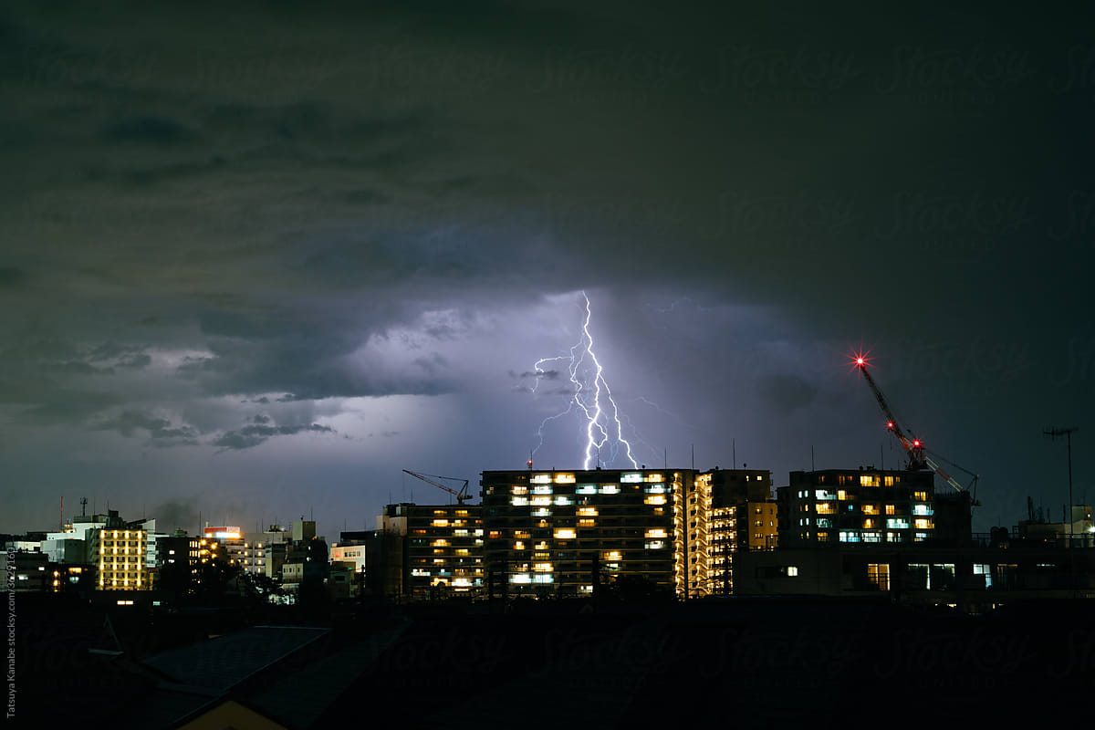 Thunderstorm over city at night