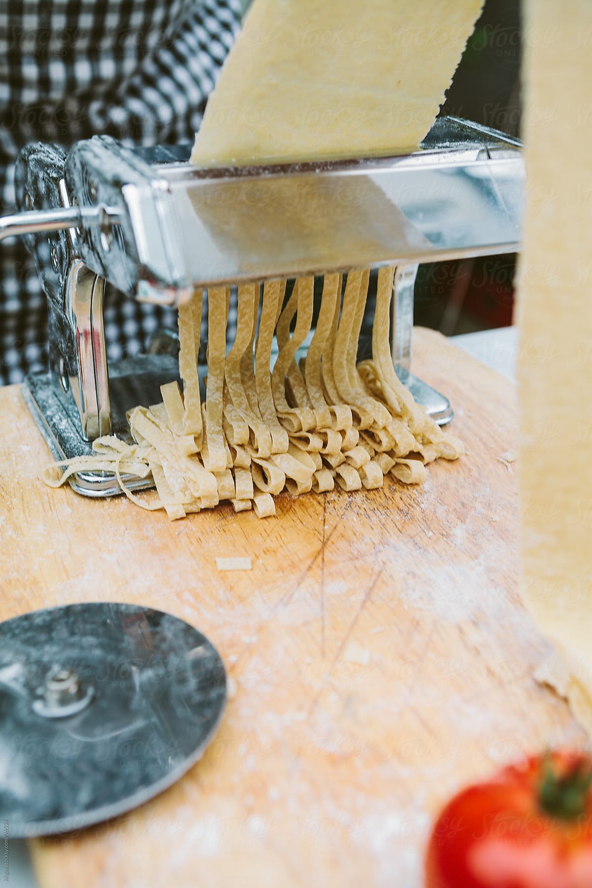 Close up of mans hand making fresh pasta with organic ingredients.