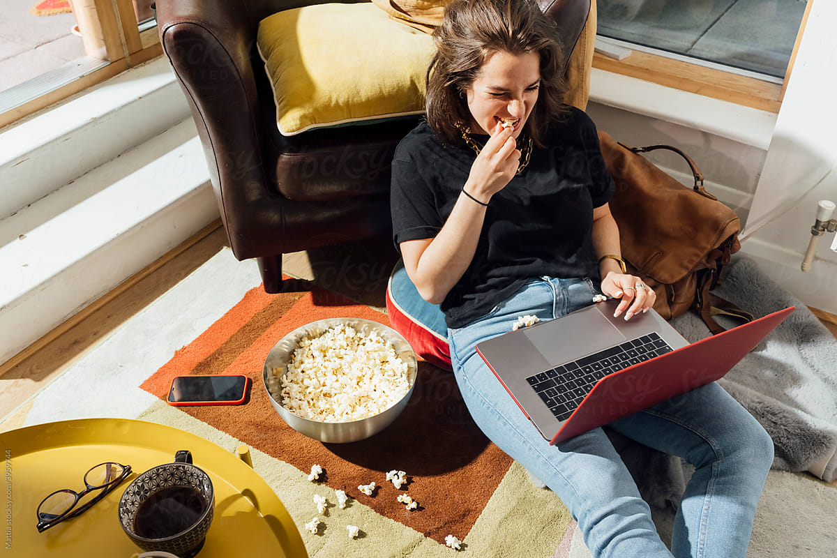 Woman eating Popcorn and watching Movies