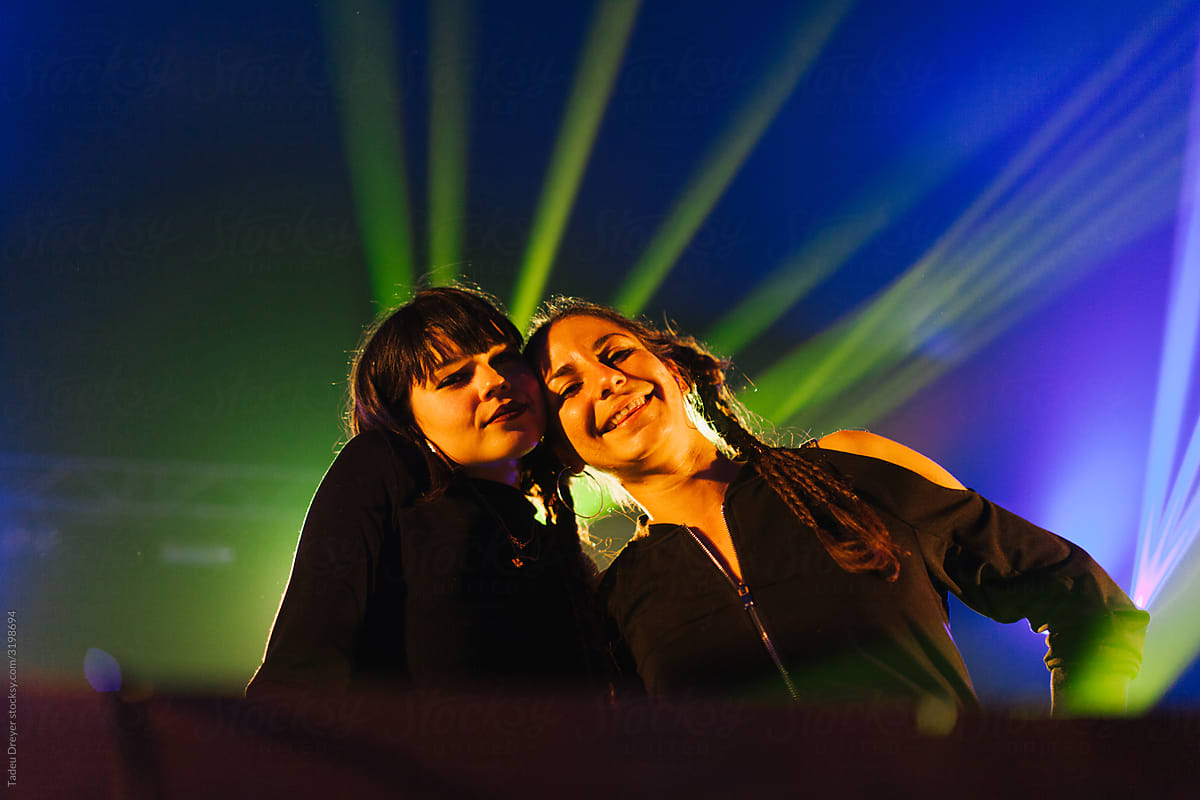 Young DJ women playing music at a party