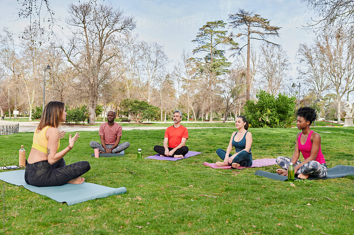 Yoga teacher talking with students outside