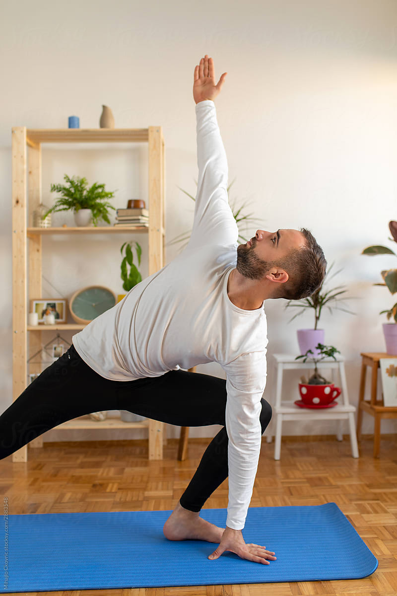 Young man doing yoga at home