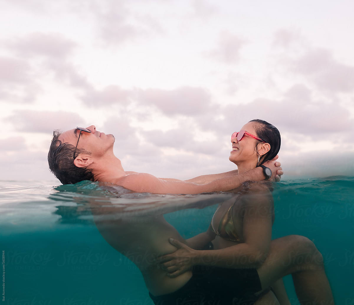 Couple having fun together playing inside the sea