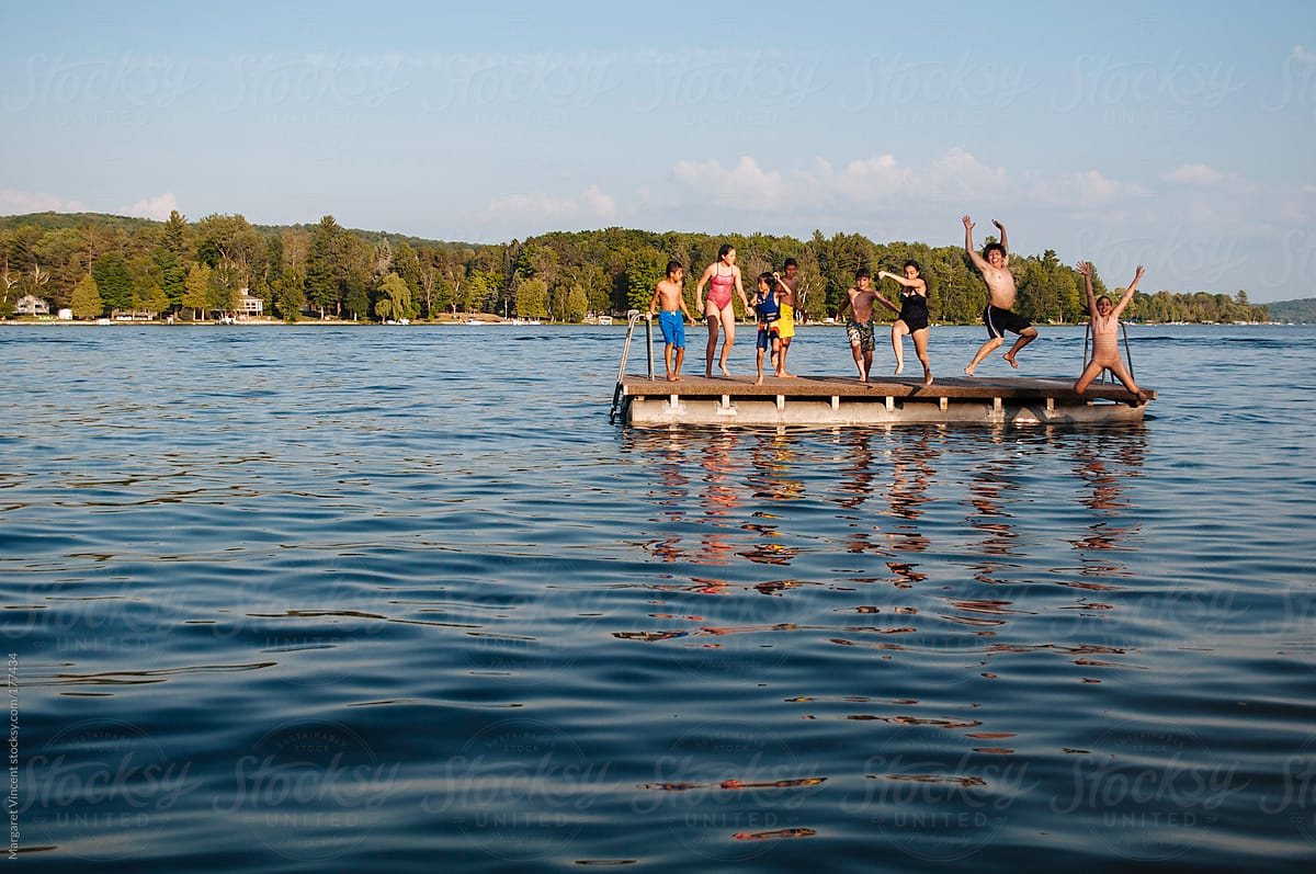a group of cousins jump off a raft