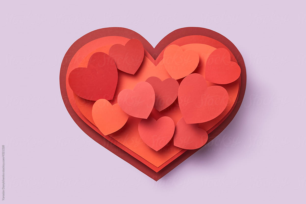 Various papercraft hearts over violet background