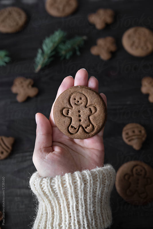 Woman holding just baked Christmas cookie