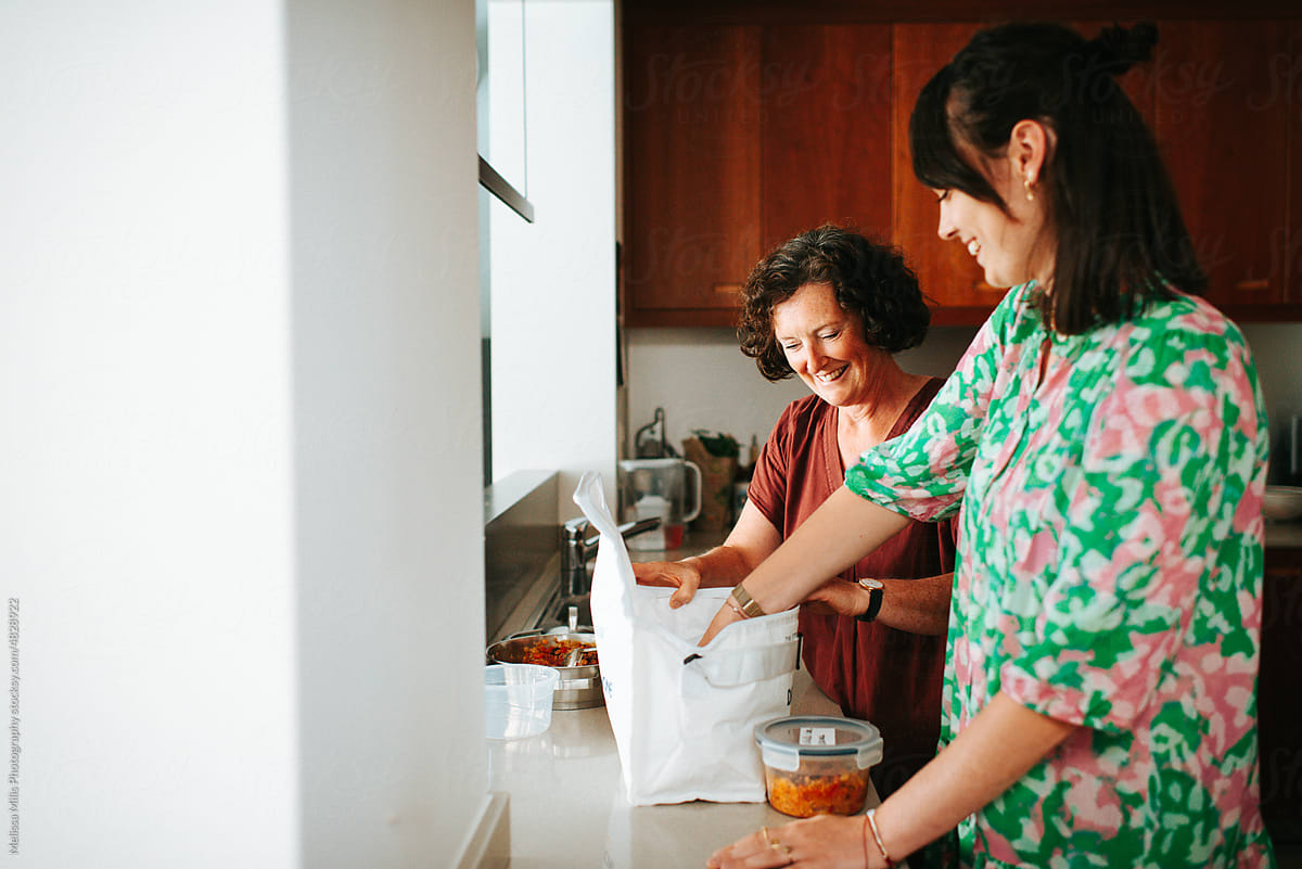 Mother and daughter prepping food in the kitchen