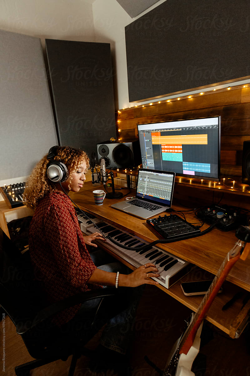 Music producer working at home studio using keyborad controller