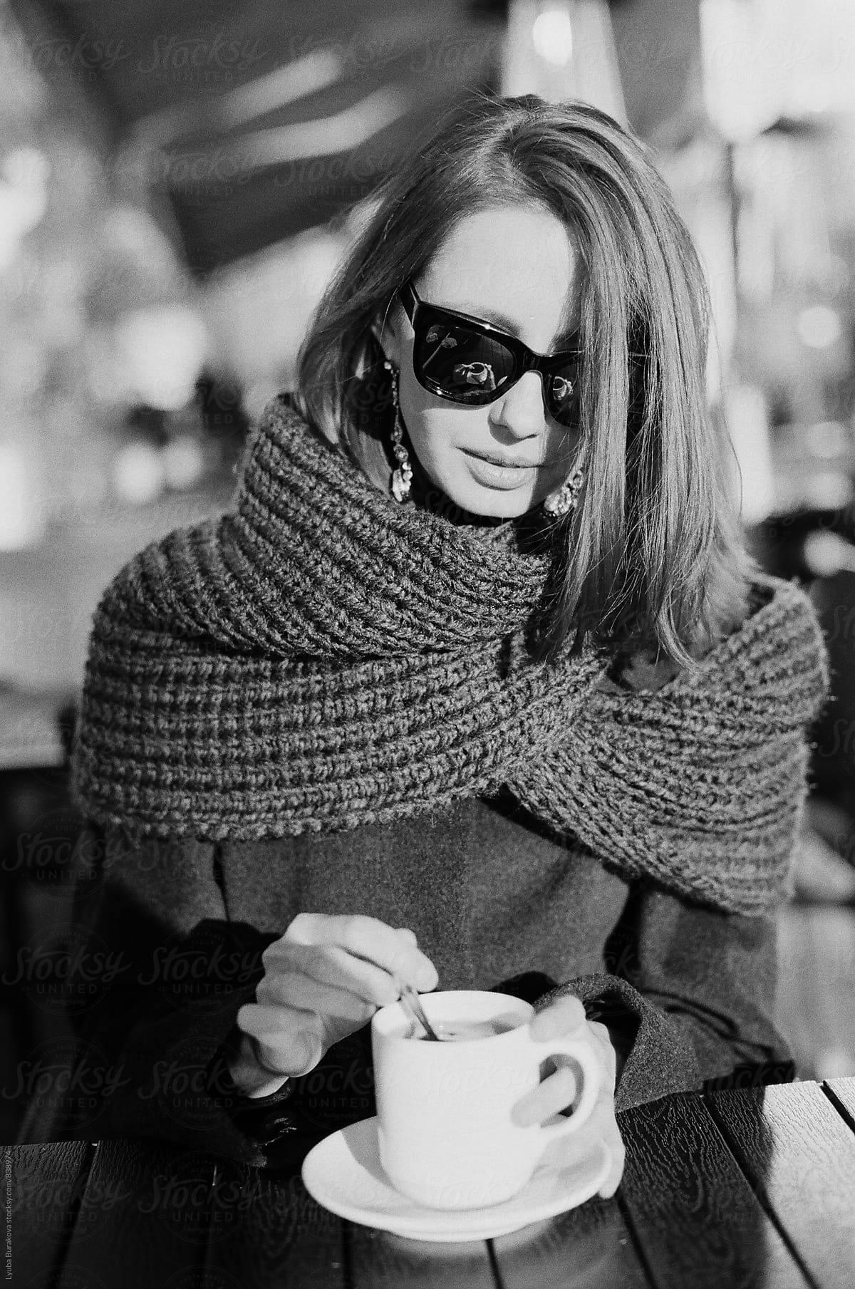 Woman drinking coffee outdoors