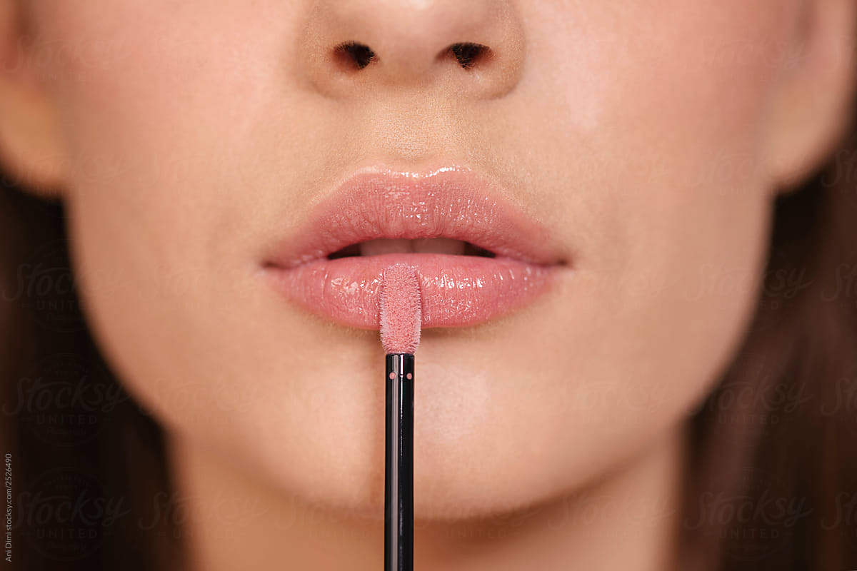 Woman putting lipstick