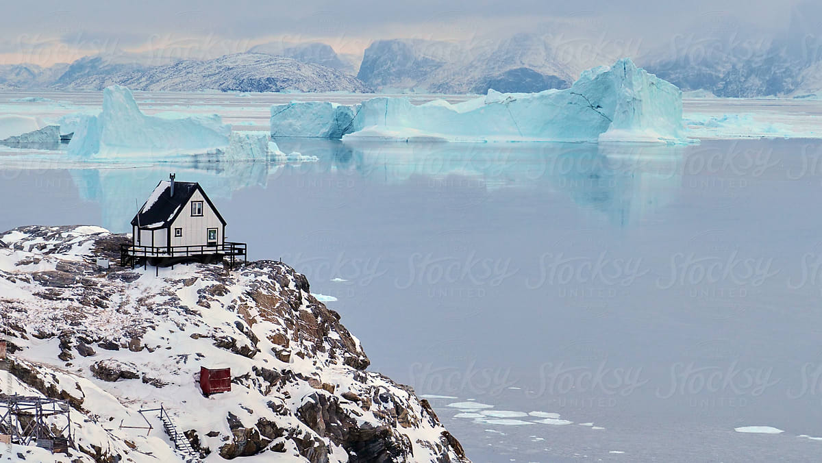 White tiny house cabin with icebergs in Uummannaq, Greenland