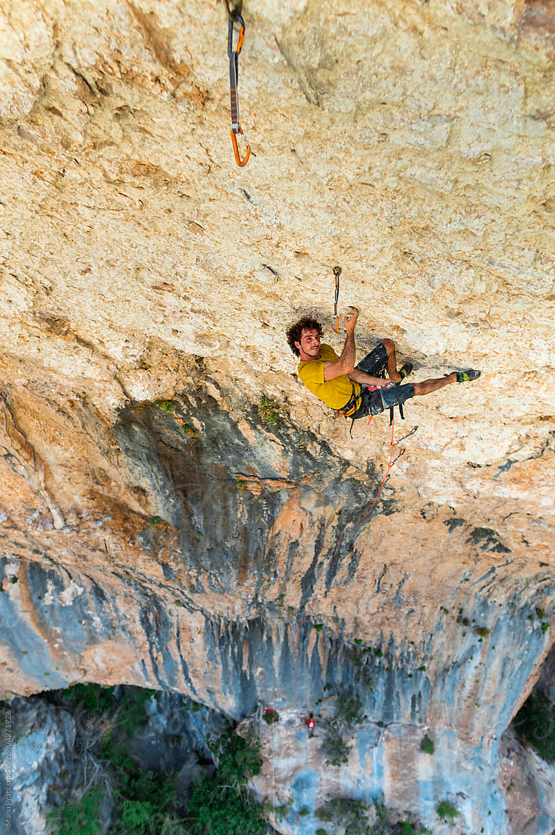 Climber rock climbing in cave