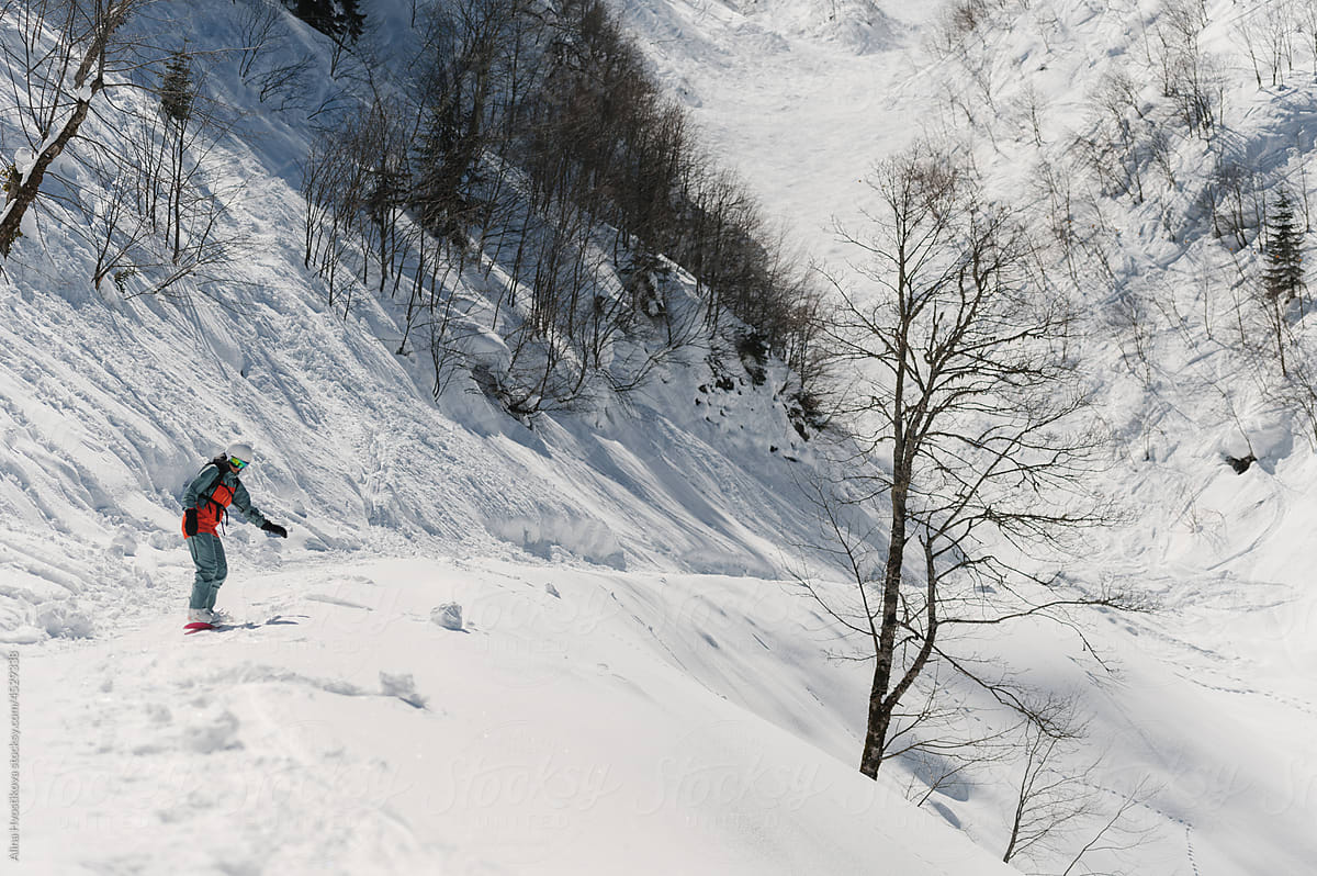 Active person practicing freeride in snowy mountains