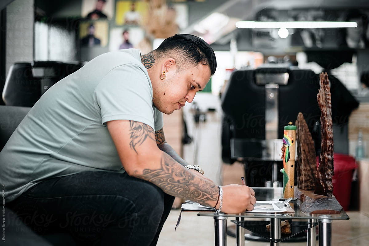 Tattoo artist drawing on a table
