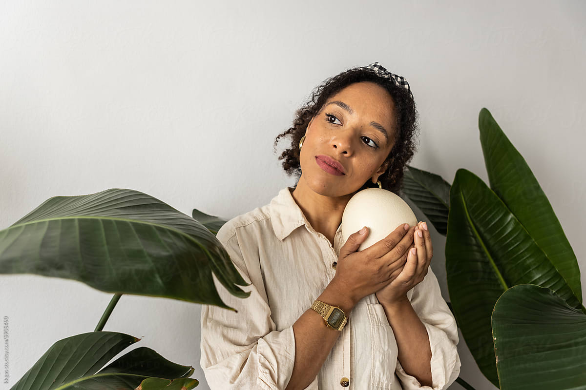 Contemplative woman with Ostrich egg