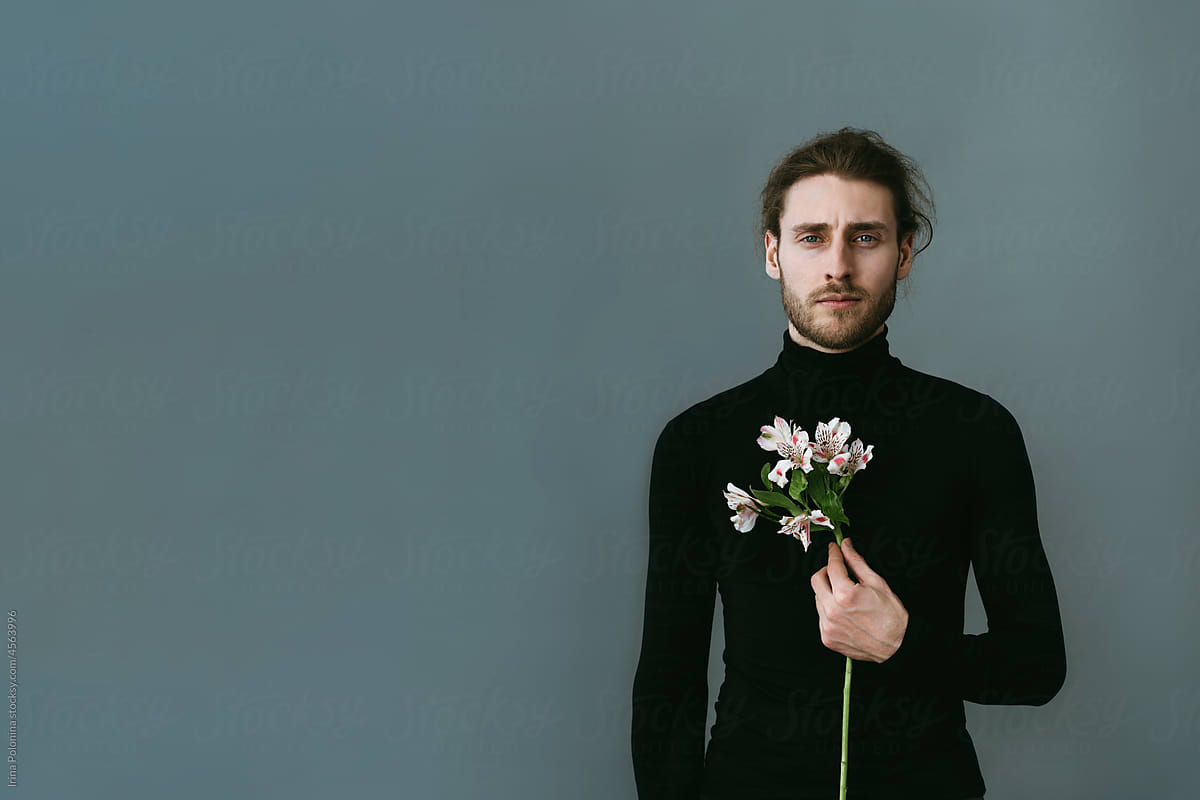Portrait of modern man with flowers.