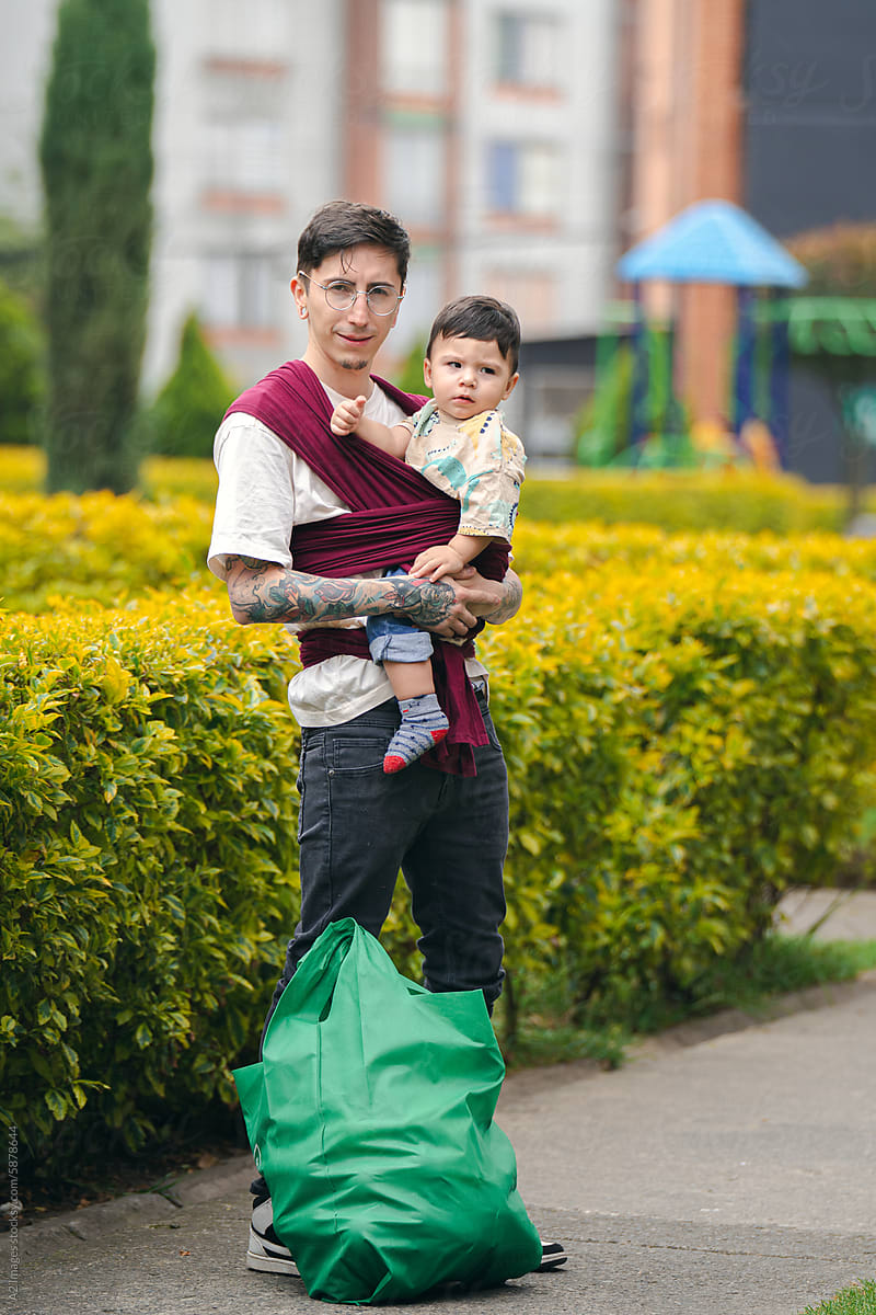 Father carrying his baby in a sling