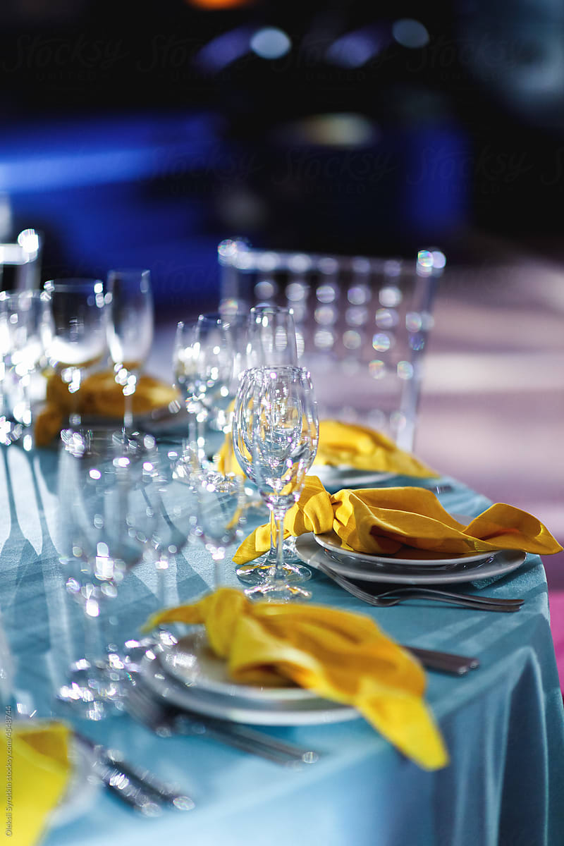 Decorated table with cutlery and dishes for guests