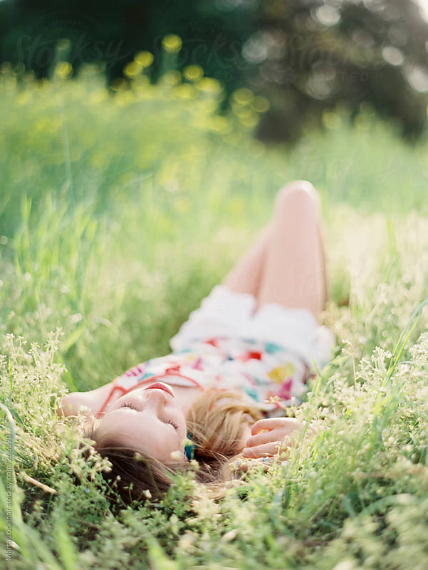 Teen Girl Lying And Napping In A Field Of Yellow Flowers By Marta Locklear Stocksy United 4952